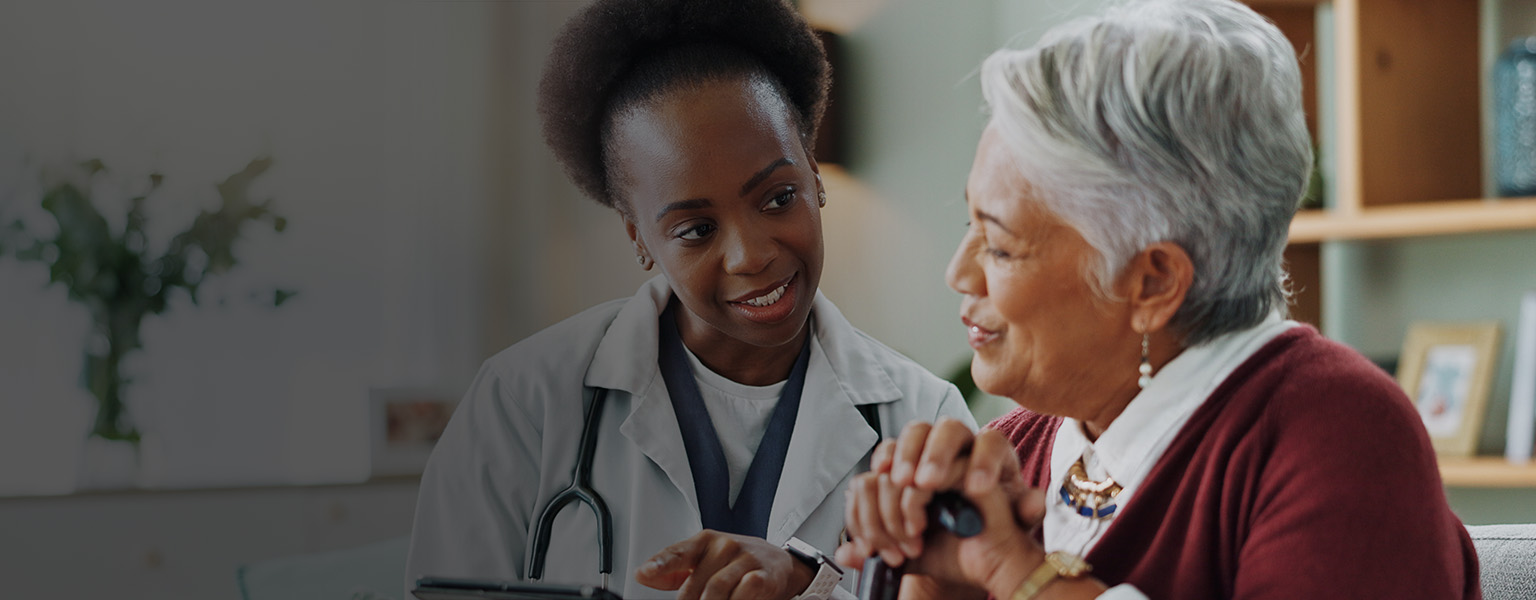 Senior woman and doctor discussing healthcare.