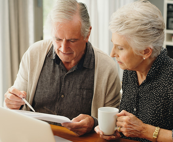 Senior couple filling out paperwork